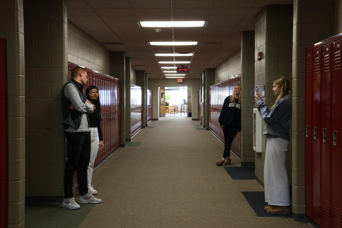 Junior Isabel Govea interviews Biology teacher Derek Roberts while junior Dakota Macchione films.