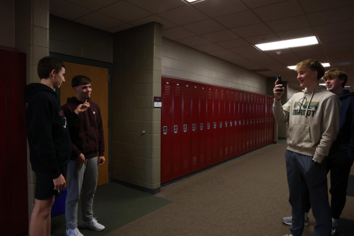 Sophomore Tommy Rhomberg interviews junior Leo Tharp while sompomore Seth Rushford films.