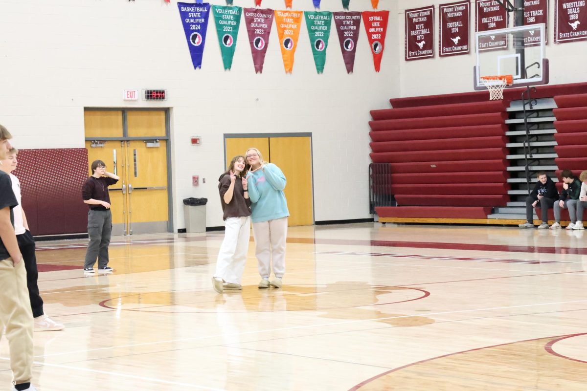 Senior Aly Lashley and sophomore Timber Scholl pose for a picture during their game of Whiffleball in the Jazz and Baseball J-Term class Jan. 8. 