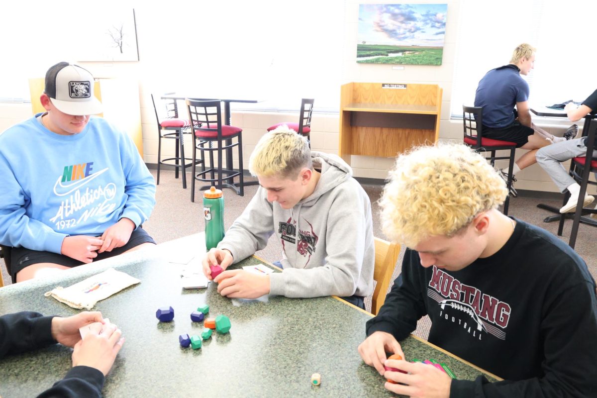 Junior Kellen Haverback and Senior Cole Thurn work on a puzzle in J-Term Mindfullness while fellow Junior Brady Weaver watches. 