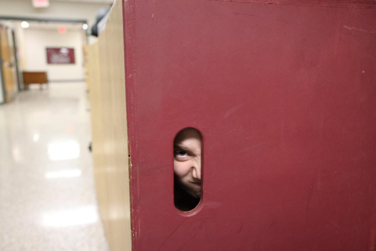 Sophomore Eastin Whisner pokes her eye through the hole of a box, Jan. 10. 