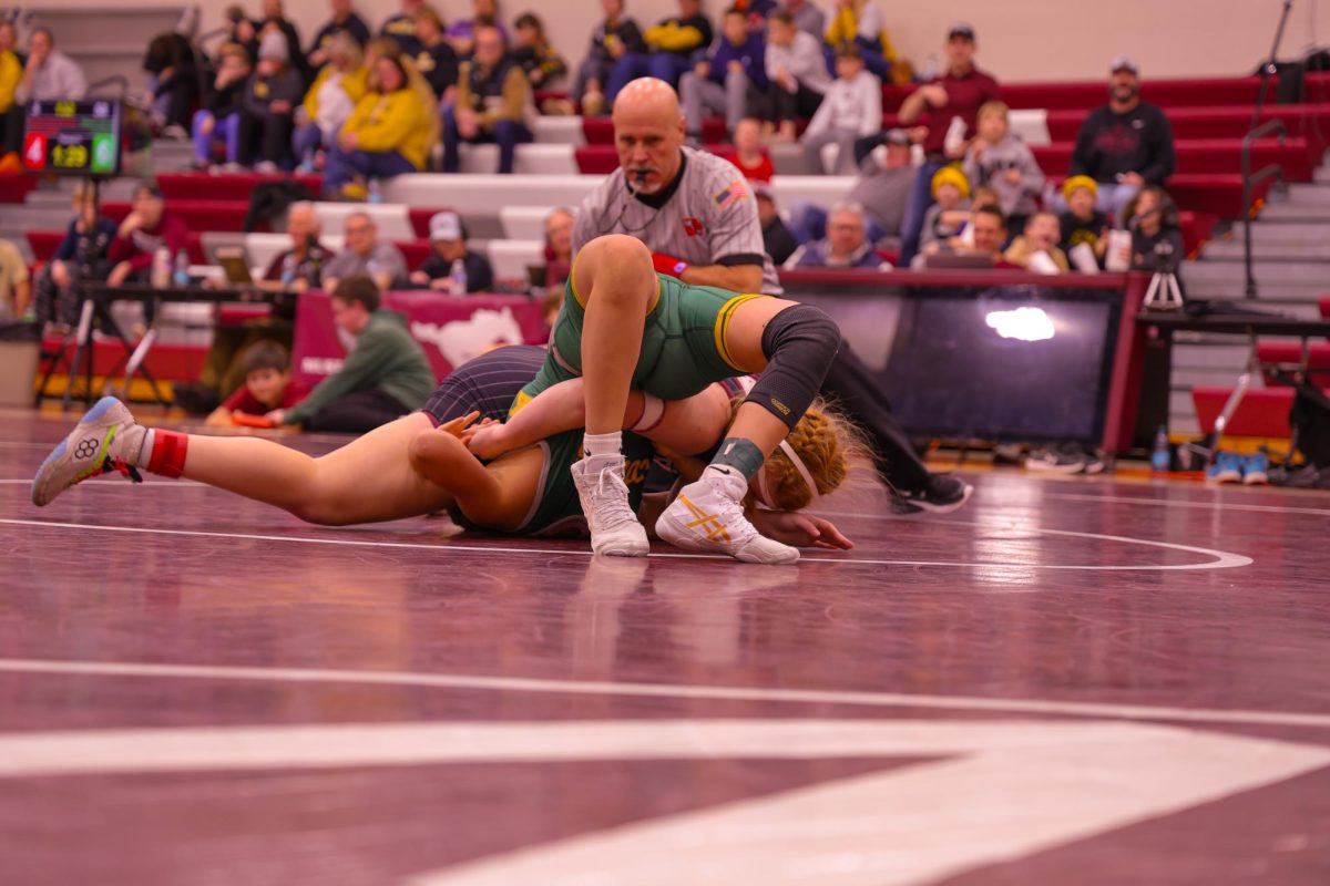 Freshman Alexi Glaza keeps her opponent on her back moments before Glaza pins her, Jan. 9. 