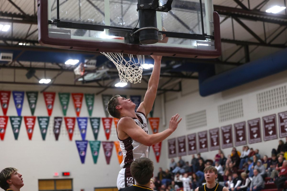 Senior Joe Briesemeister goes up for a layup as CPU players watch in amazement.. 