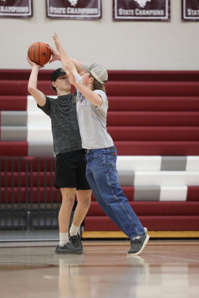 Sophomore Nathan Nederhiser attempts to block LJ Korte during their basketball game in the Exercise Science J-Term.