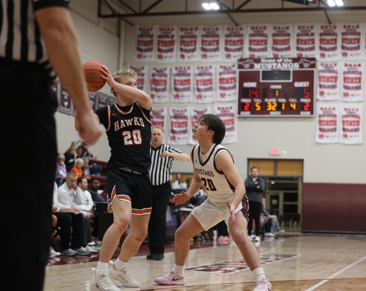 Sophomore Stratton Ellyson (20) stares his opponent down while blocking him. The Mustangs ended up winning against the West Delaware Hawks 72-36 on Jan. 28. 