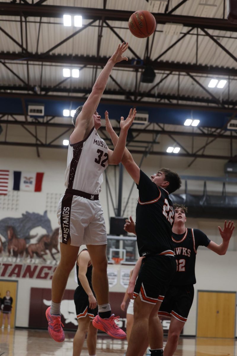 Senior Josef Briesemeister (32) jumps to shoot the basketball into the net Jan. 28.