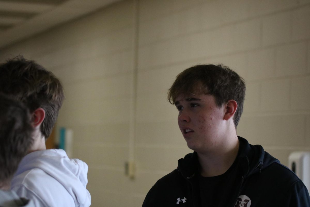 Sophomore Alex Briesemeister watches along as his classmates take photos.