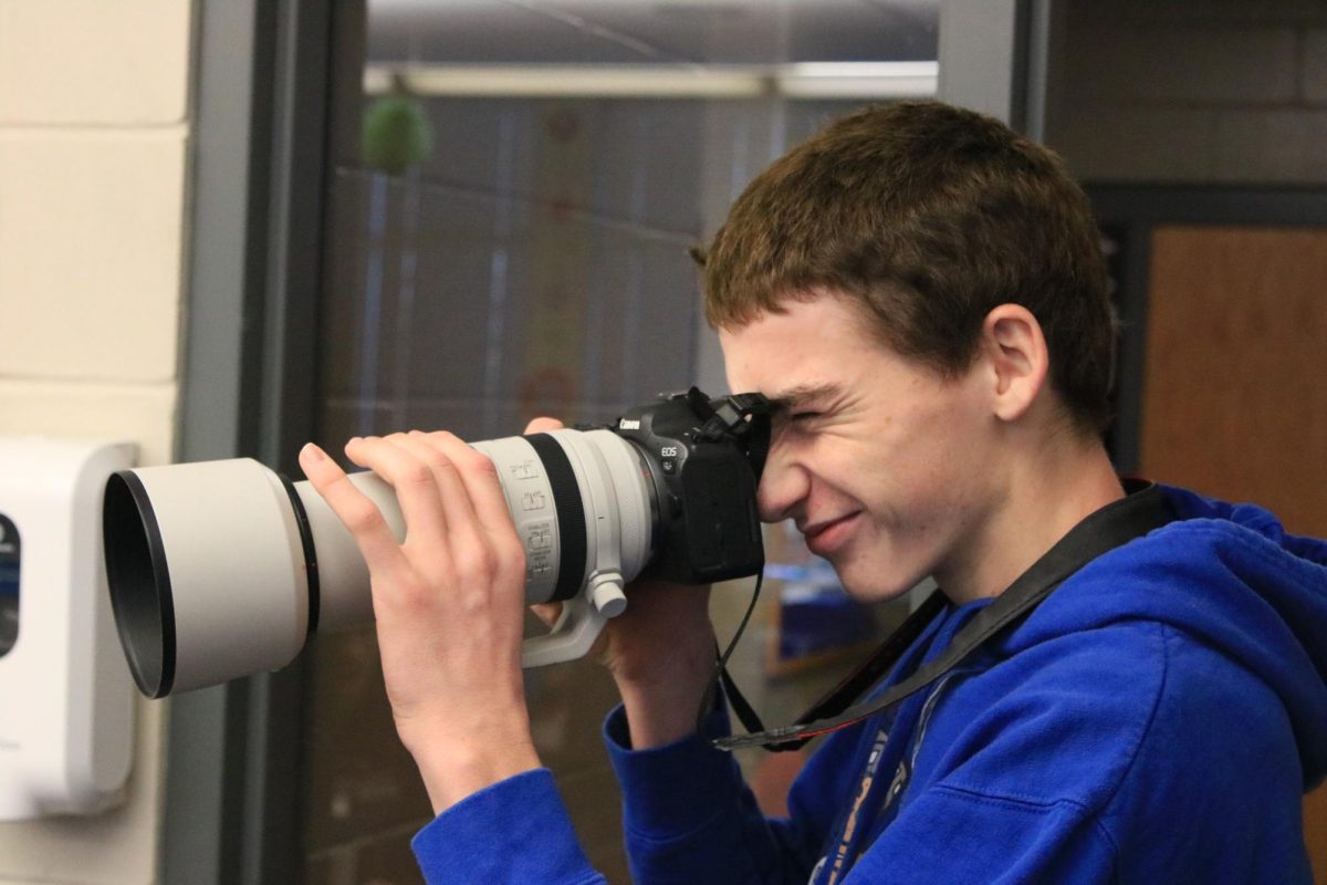 Sophomore Tommy Rhomberg adjusts the lense of his camera for an action shot in the Digital Media J-term course. 