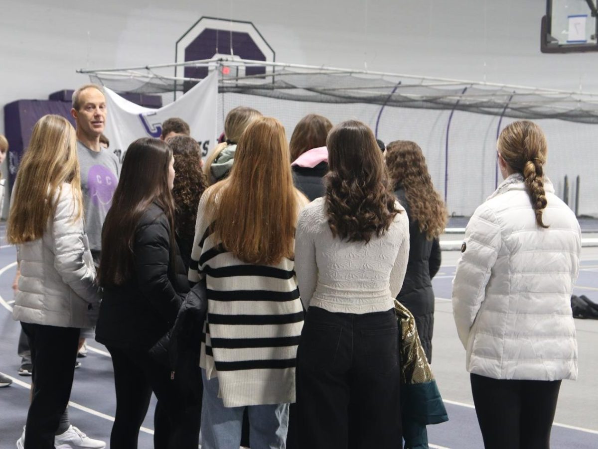 Freshmen listen and prepare to play games at the Cornell gym.