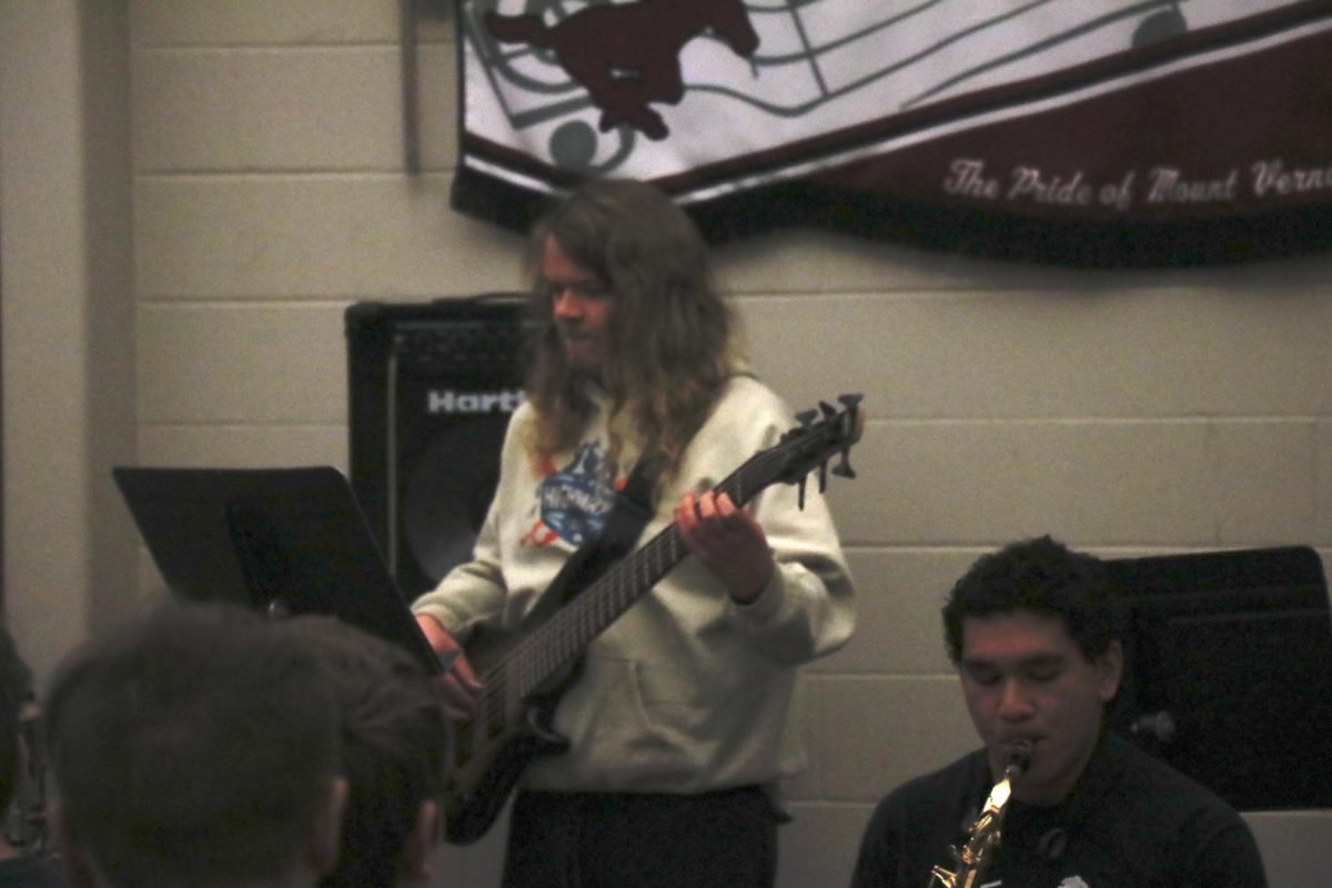 Senior Nick Alles plays electric bass during a demonstration for the Baseball and Jazz J-Term.