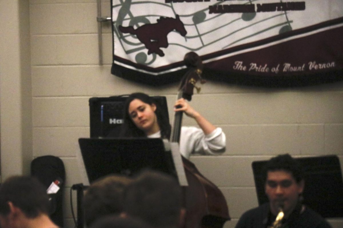 Junior Carrington Bybee plays string bass during a Jazz Ensemble performance.