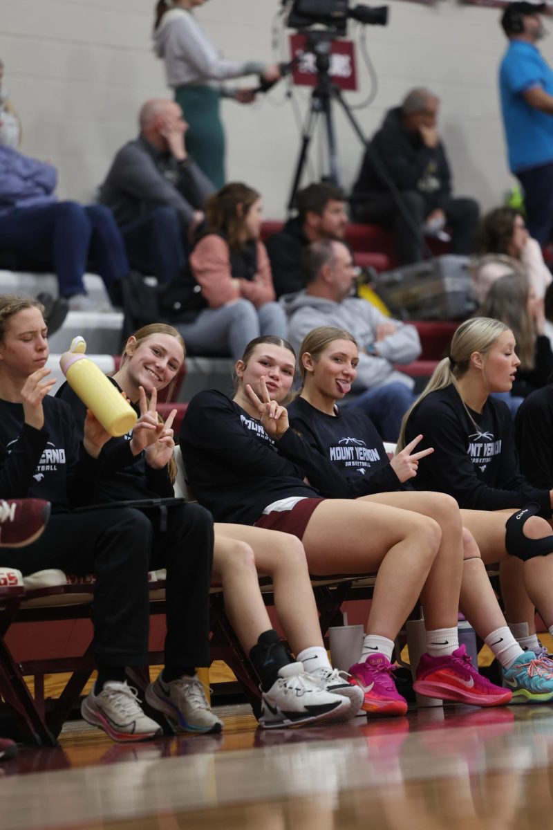 Freshman Ella Wilson and Sophomores Sophia Meester and Lucy Wischmeyer pose for a photo during their game, Jan. 15. 