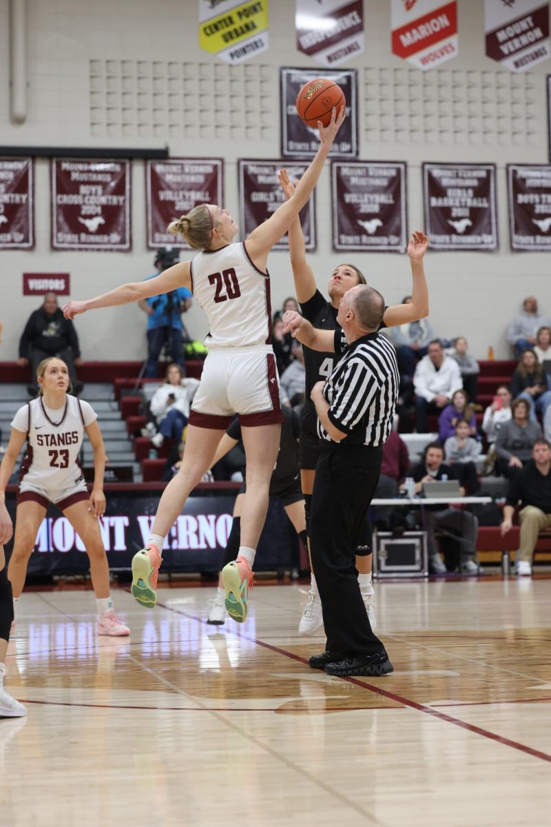 Senior Chloe Meester (20) wins the tip at the beginning of the game, Jan. 15.