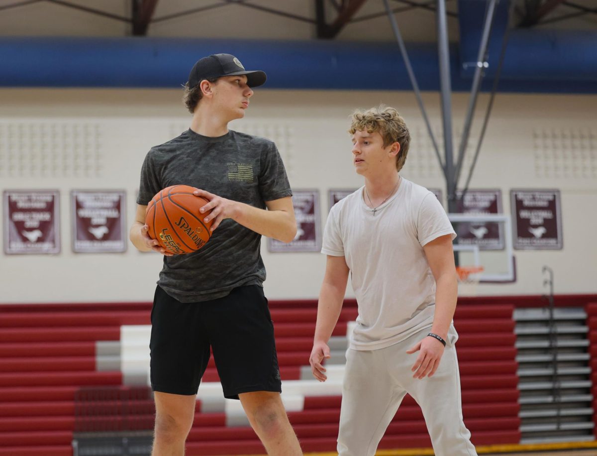 Sophomore Brody Miksch gaurds junior LJ Korte in a basketball game during their Exercise Sceince J-Term class.