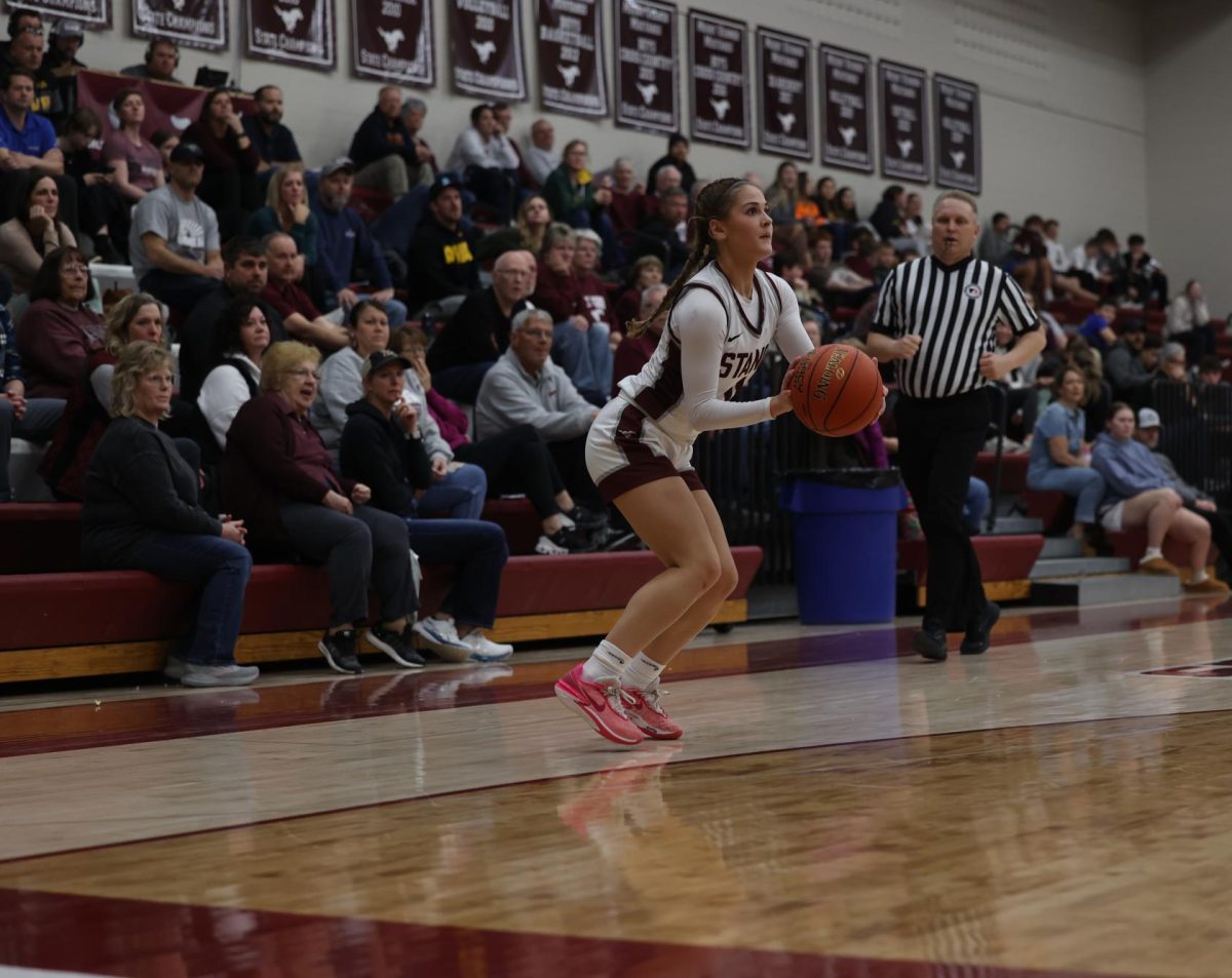 Junior Taylor Franck (11) stops at the three point line to shoot the basketball Jan. 28.