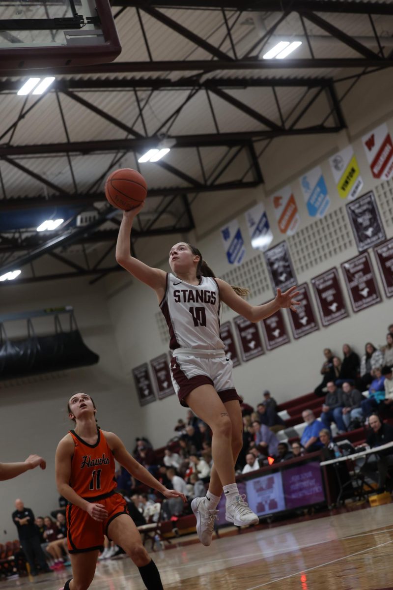 Freshman Savanna Wright (10) jumps to shoot the ball one handed Jan. 28.