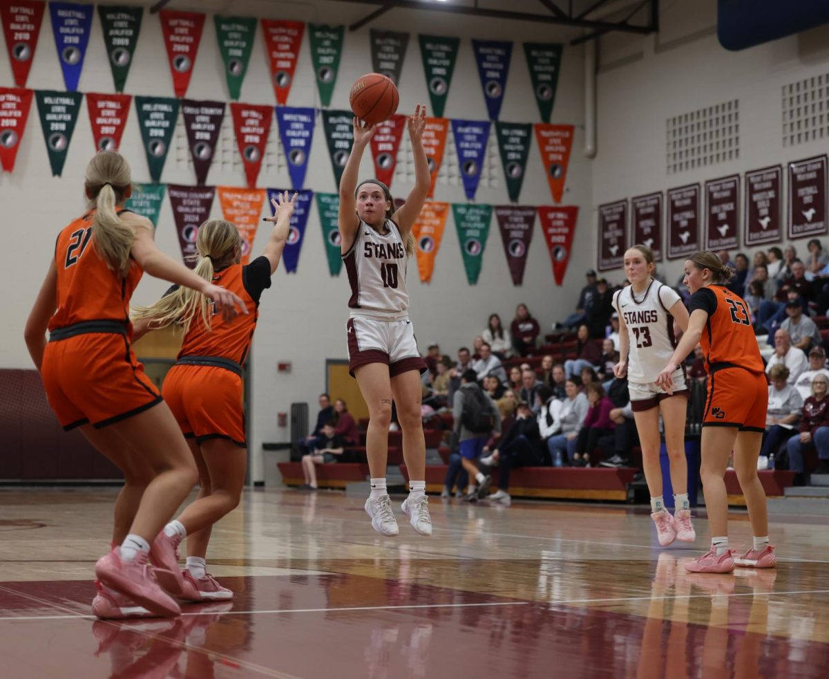 Freshman Savanna Wright (10) jumps to make a two-pointer Jan. 28.