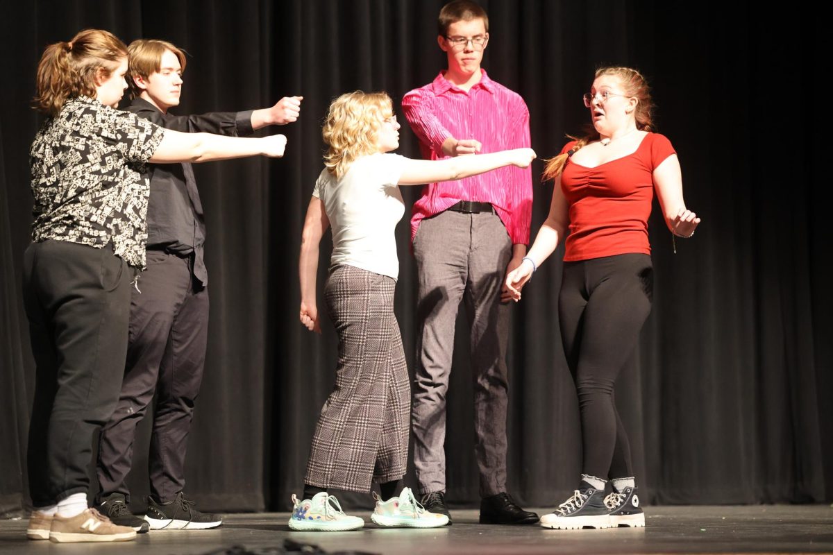 The cast of Hamlet points their daggers at Gertrude played by Senior Violet Olinger Feb.15.