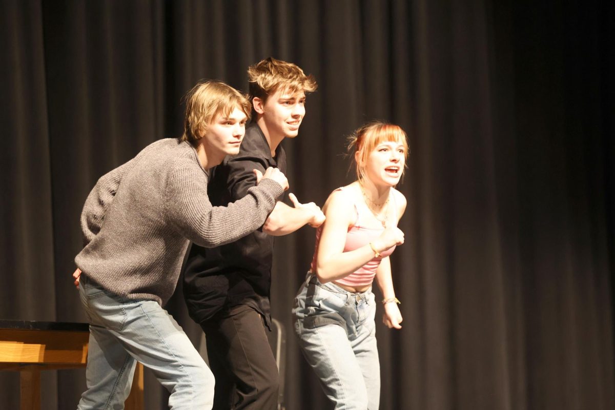 Juniors Grant Tucker, Kevin Zehms and senior Skye Rodman in their ensemble acting "Sports" Feb.15.