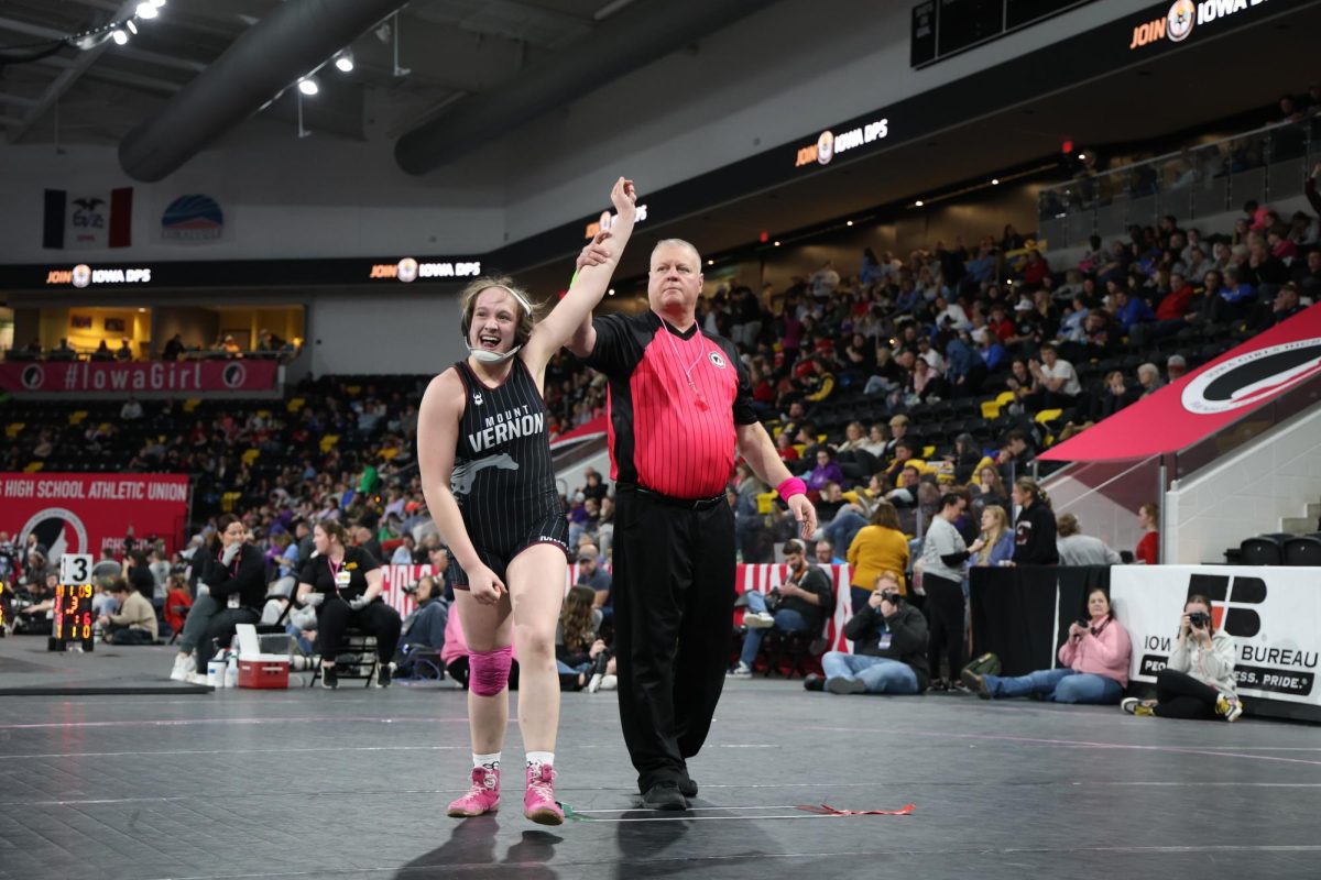 Junior Gracie Pinckney (170) has her arm raised, cinching the 5th place at state. Pinckney won 45-6, over Briar Blake (North Tama) 28-3, (Fall 5:19).