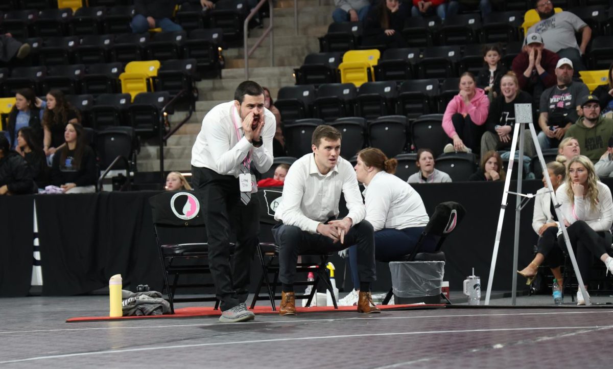 Coaches Chance Shelton and Trevor Trende cheer at state Feb. 7