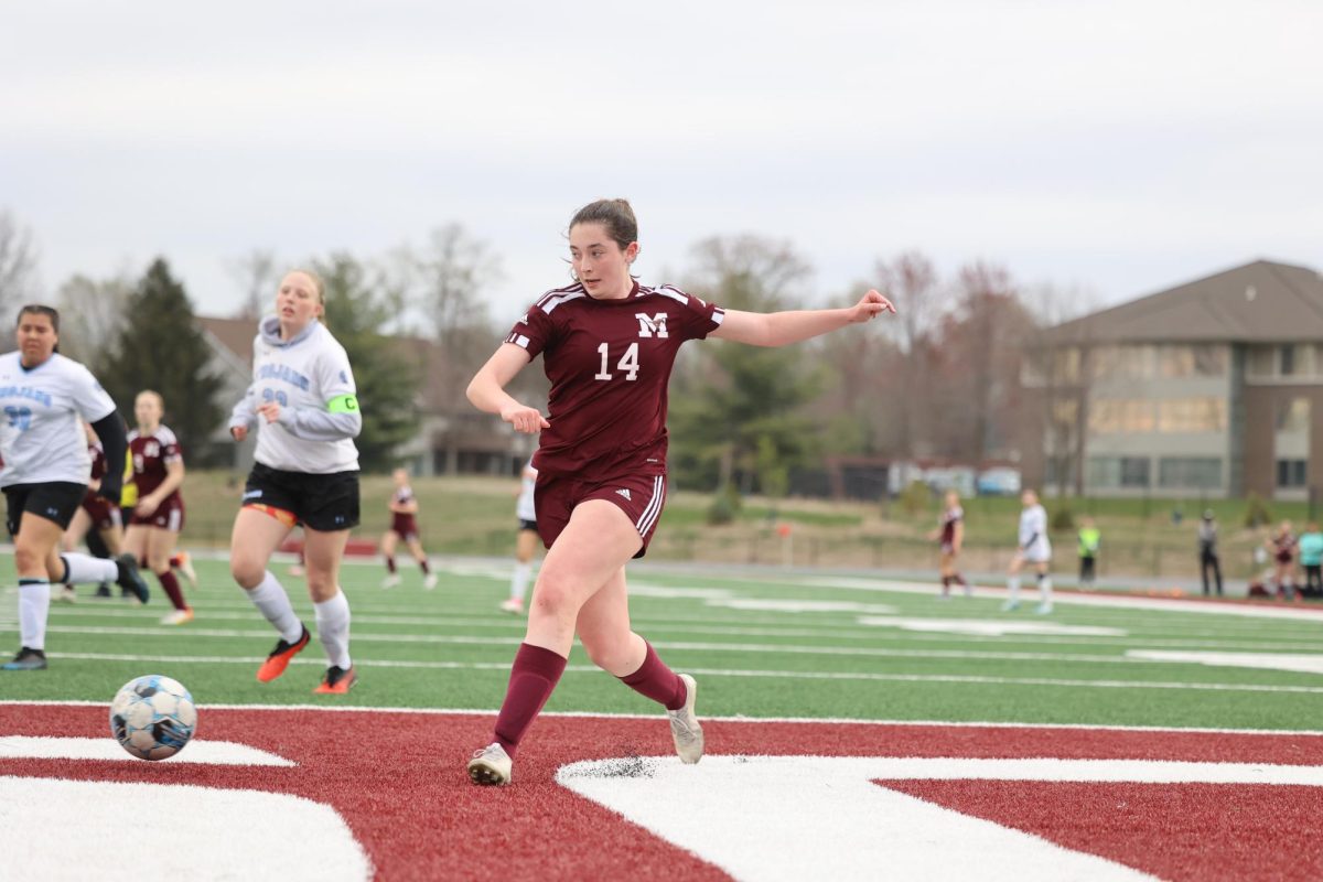 Senior Clare Nydegger (14) passes the ball for an assist April 17. 