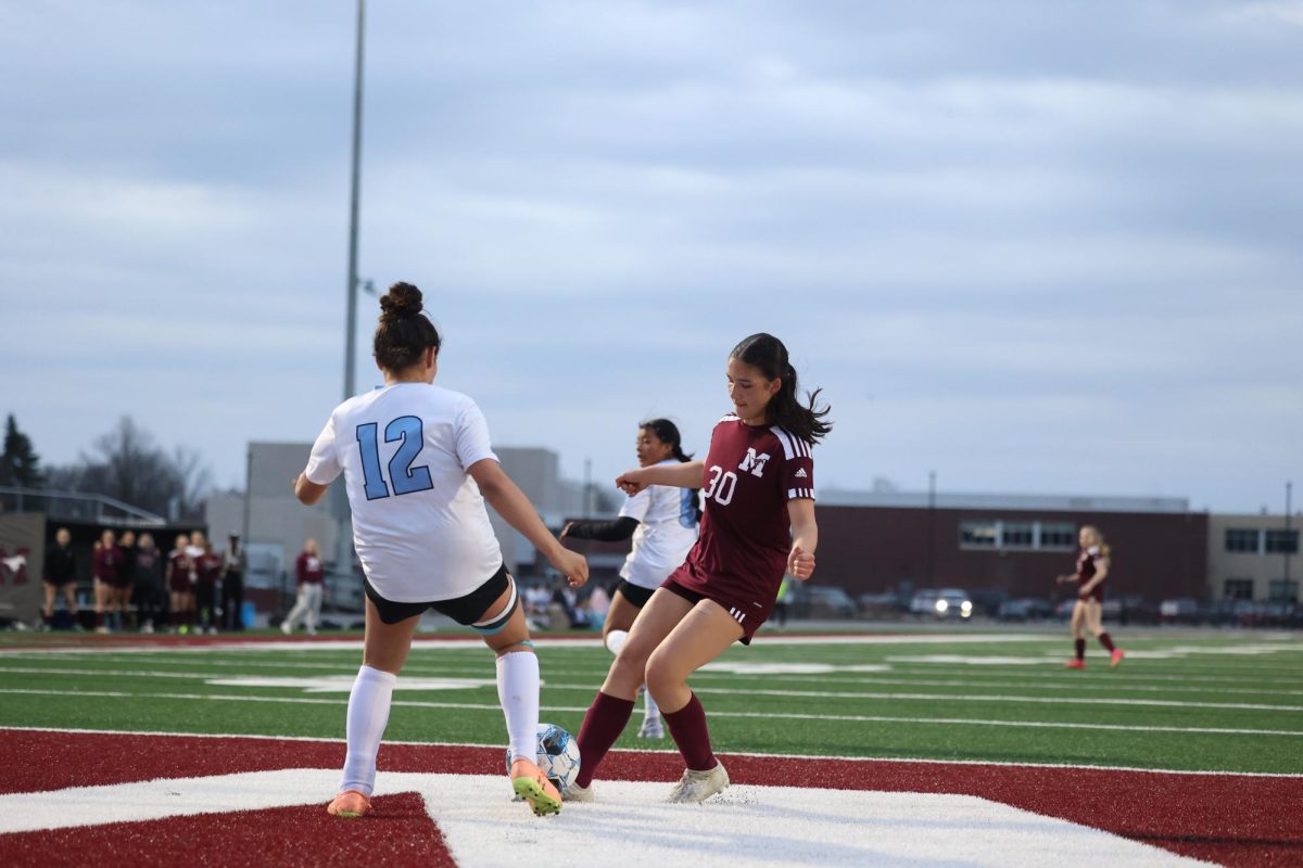 Freshman Liliana Grosse (30) fights for the ball against South Tama opponent April 17. 