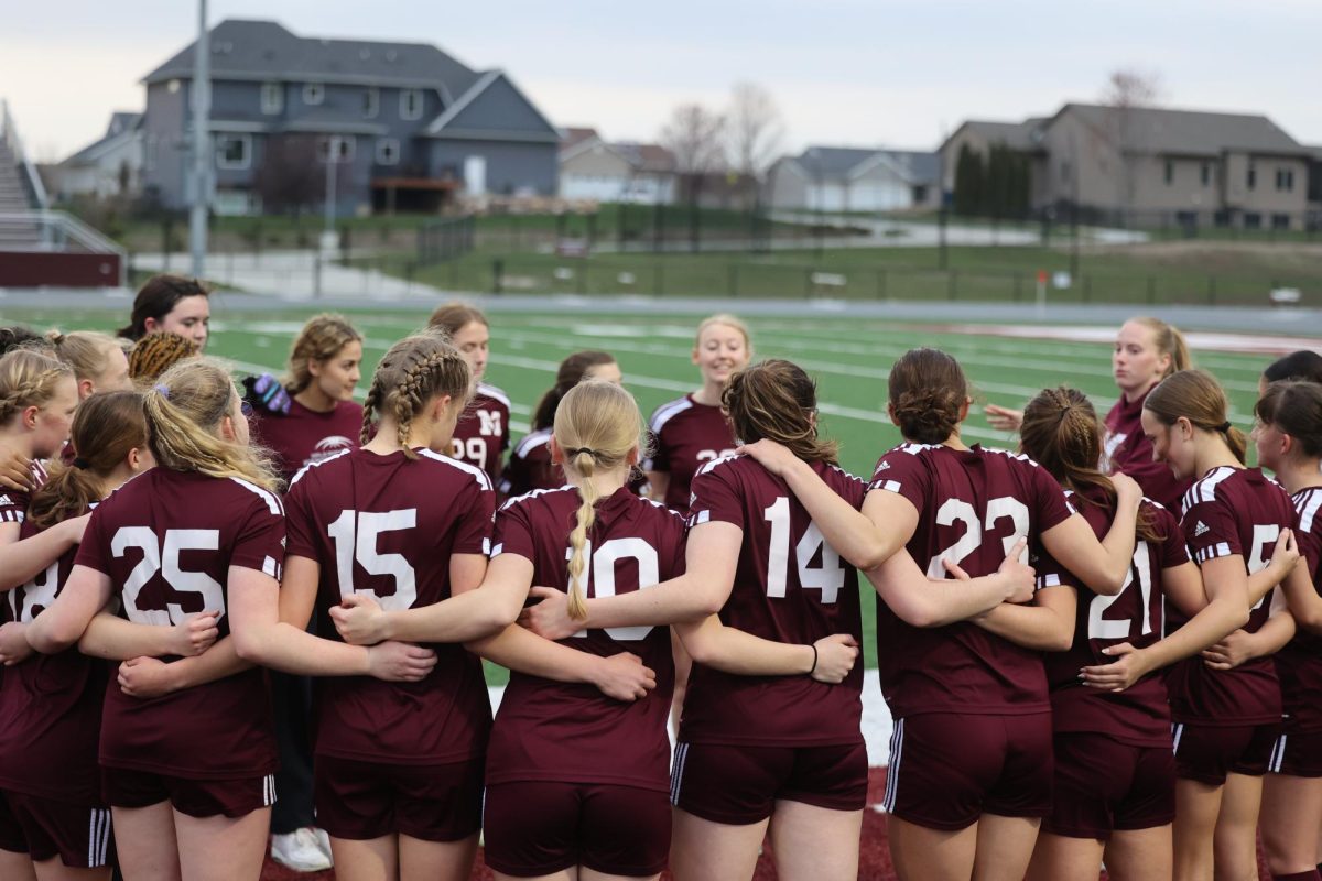 The Mount Vernon girls soccer team circles up for a pep talk from coach knies before the game starts. The Mustangs won and ended the game early against South Tama after scoring 10-0 on April 17. 