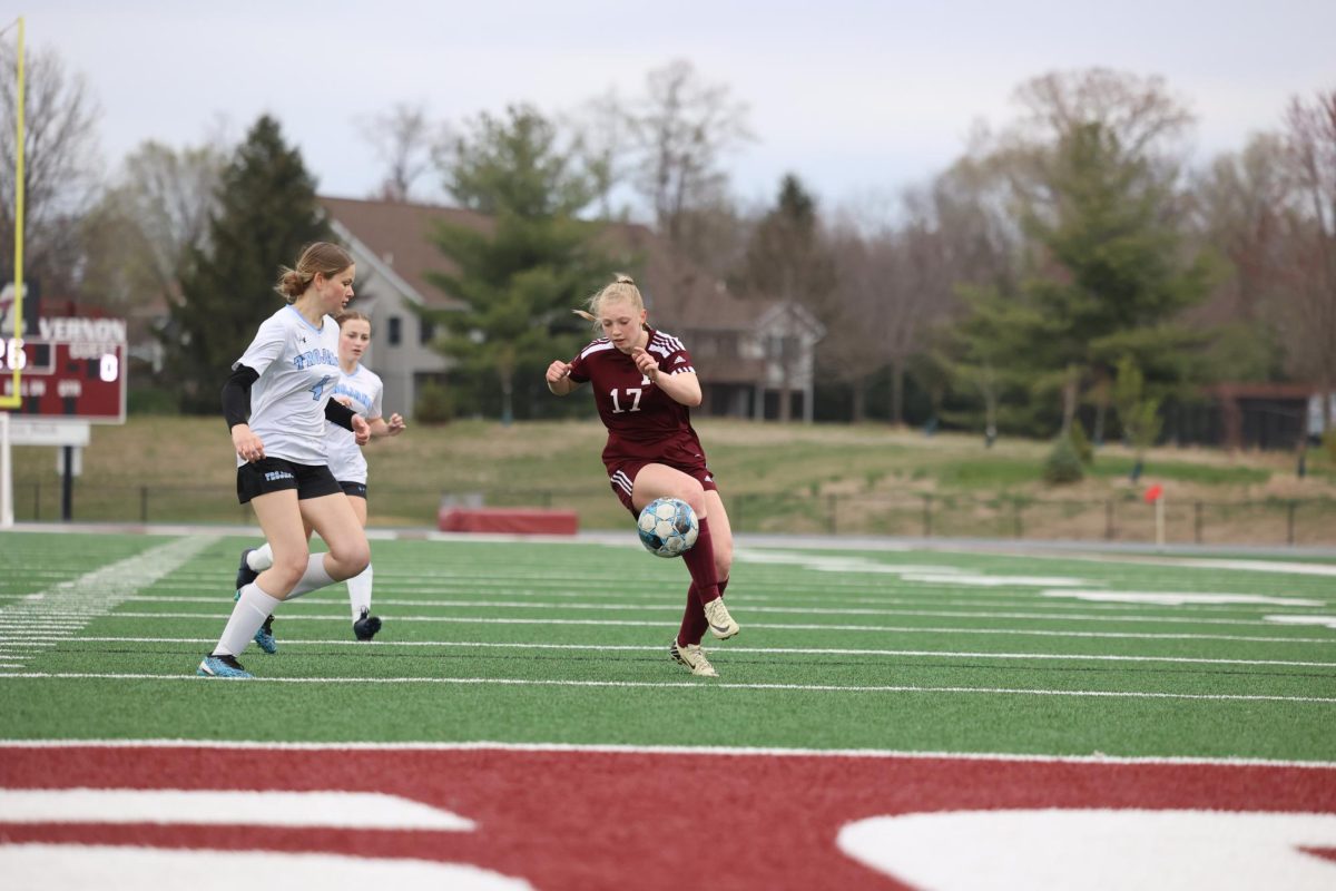 Junior Izzy Logue (17) settles the soccer ball by letting it hit her knee and drop to the ground April 17.