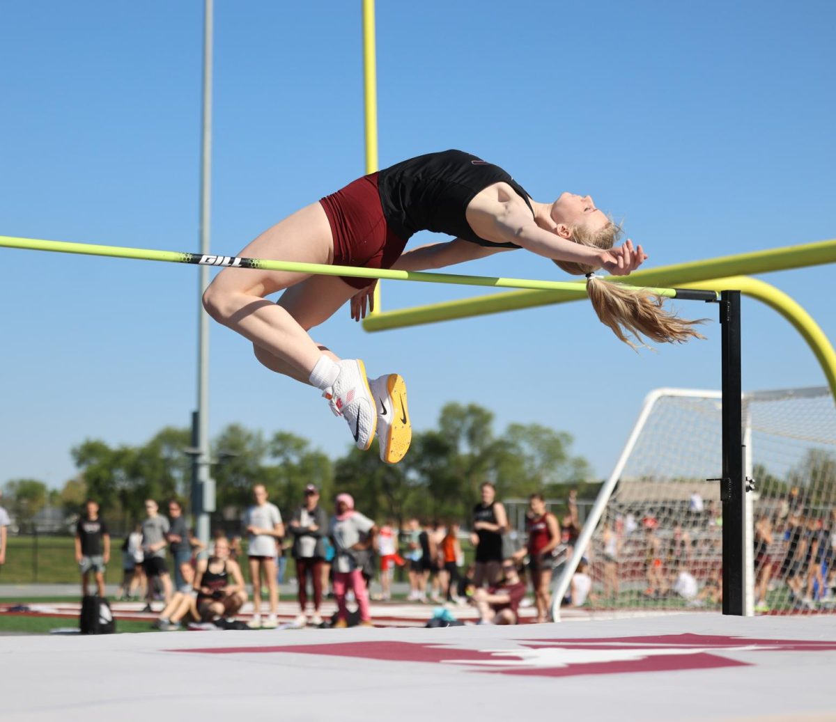 Senior Sydney Maue glides gracefully over the high jump bar during the WaMaC conference meet. Sydney jumped a height of 5'8", and new personal, meet, and school record on May 8. 