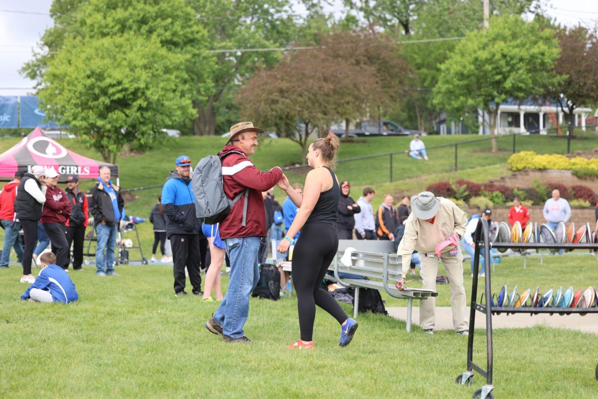 Libby Dix is congratulated on her performance by Coach Ed Timm.