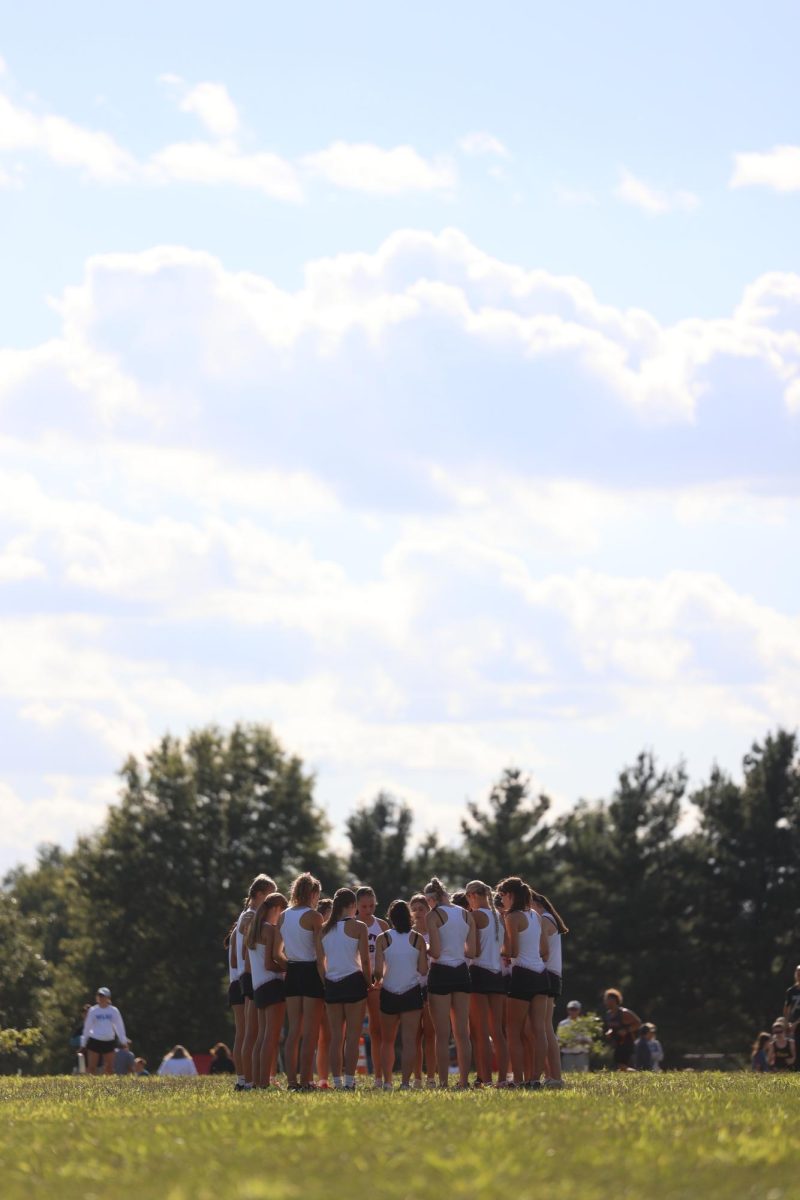 Mount Vernon-Lisbon Girls Cross Country team gathers for a thought before their race.