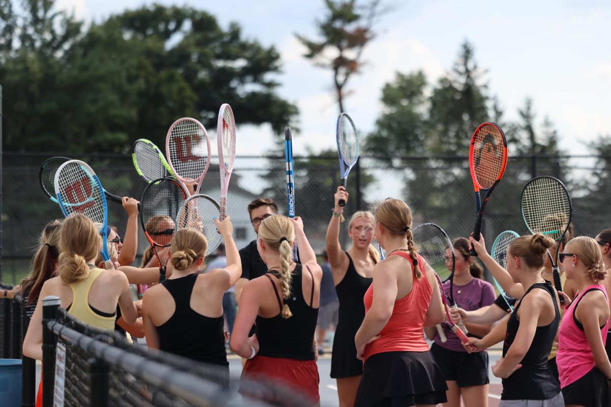 The Tennis team raises their rackets after a pep talk. The Mustangs  beat Independence 7-2 on Aug. 28. 