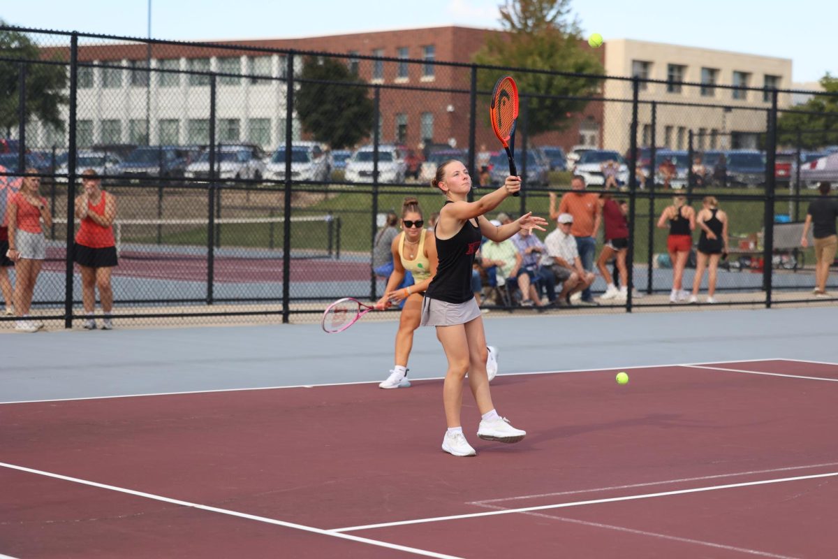 Sophomore Emily Schnoor and senior Polly Hinrichs warm up their returns. The Mustangs beat Independence 7-2 Aug. 28.  