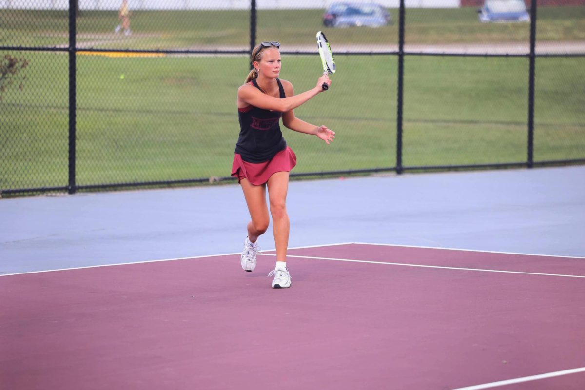 Junior Nora Dye waits for the ball to return to her opponent after a hit. The Mustangs beat Independence 7-2 Aug. 28. 