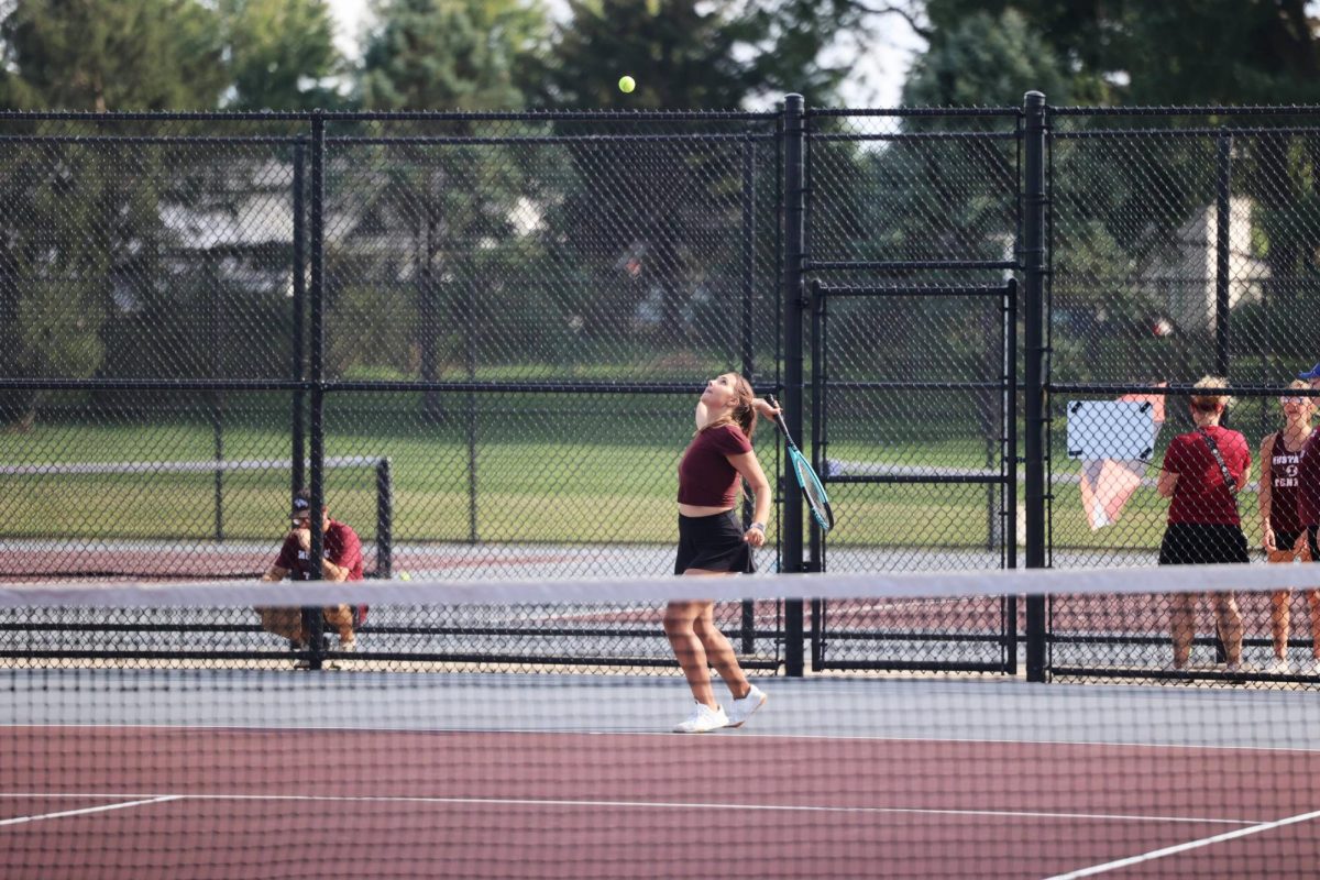 Senior Ashtyn Rollinger waits in anticipation to serve the ball. The Mustangs beat Independence 7-2 Aug. 28. 