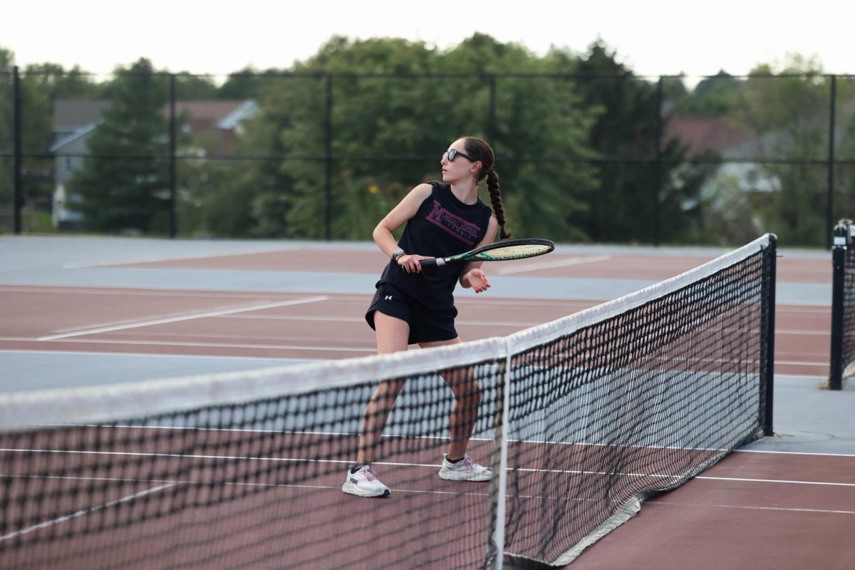 Junior Anna Stephens looks back at her partner's serve. The Mustangs beat Independence 7-2 Aug. 28. 