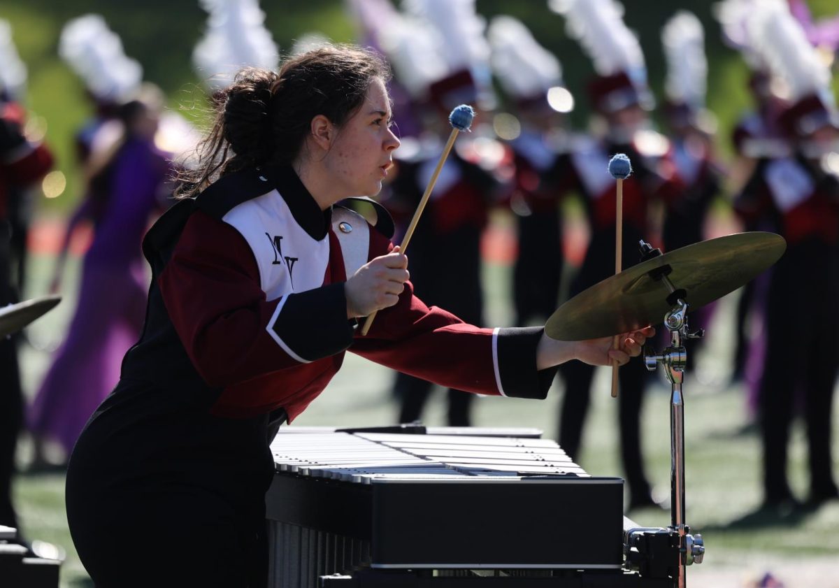 Senior Carrington Bybee plays with the pit during the Marching Mustangs' show at the Linn-Mar marching band competition. 