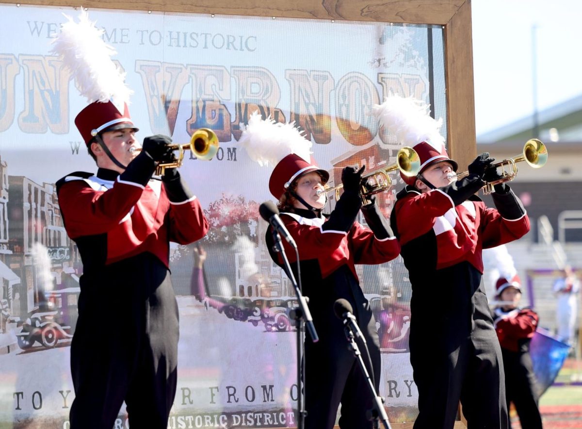 Seniors Samuel Neira, Eva Bishop, and Mya Stoner perform a trumpet solo together during the Linn-Mar marching band competition. 