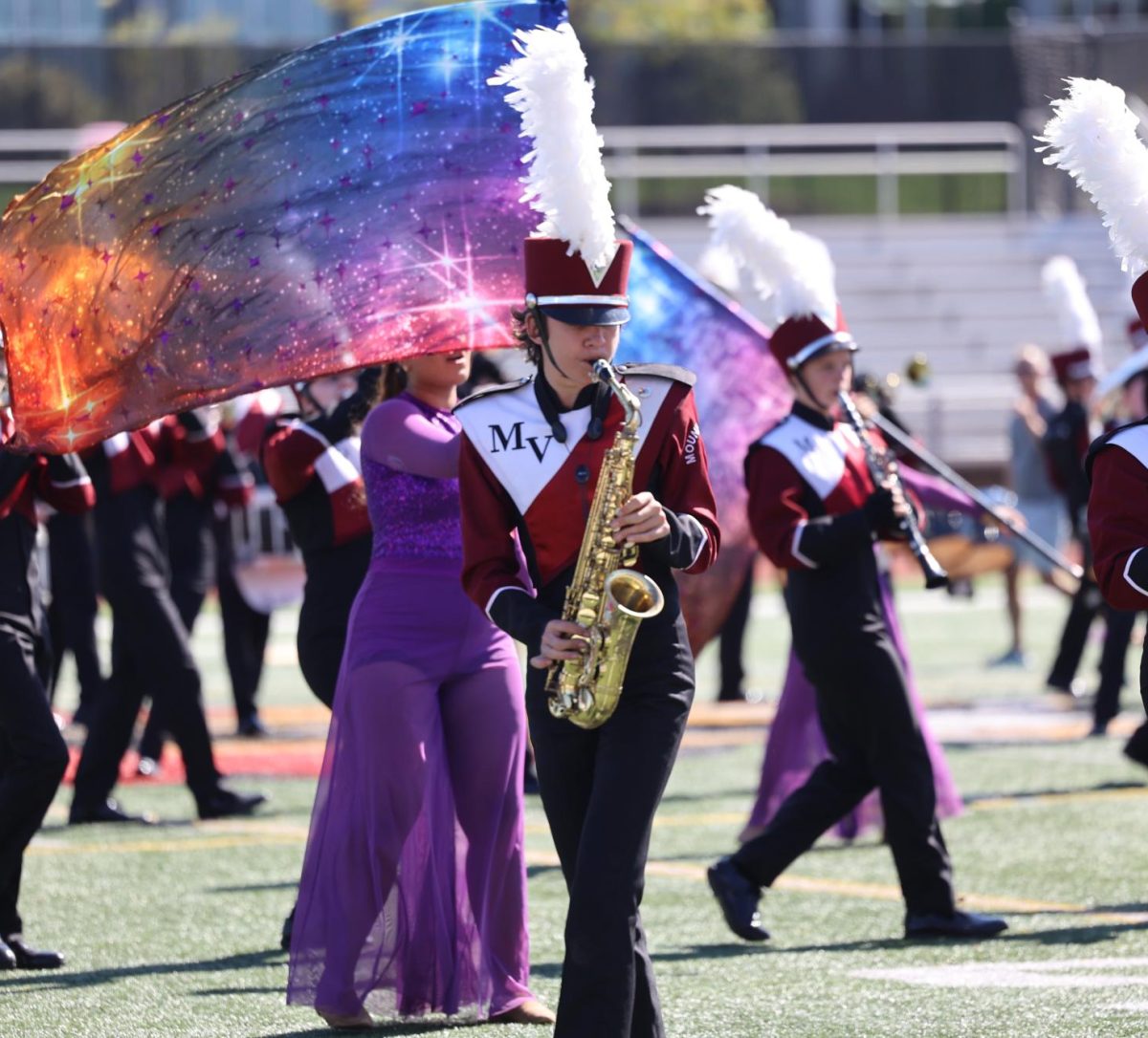 Sophomore Elliott McNulty marches with the band on the Linn-Mar field. 