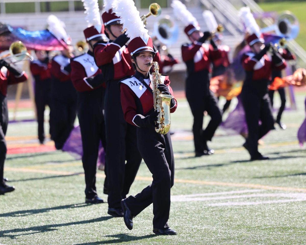 Senior Jae Williams marches with the band during their show at Linn-Mar on Sept. 27. 