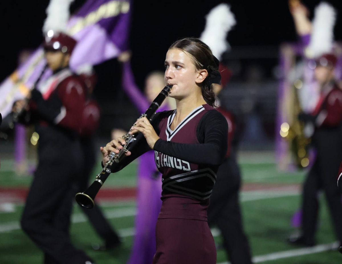 Junior Lyn Bauer marches during the Marching Mustangs' halftime show.