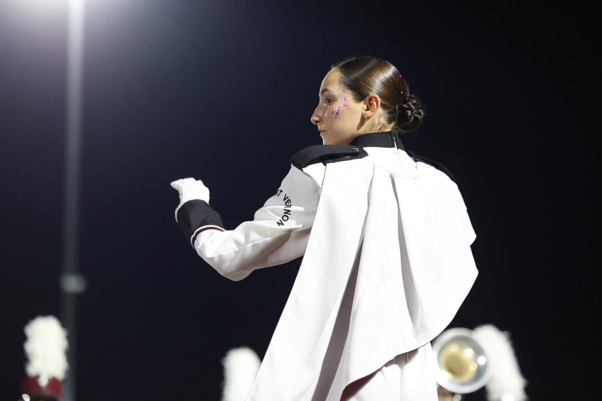 Junior Drum Major Anna Stephens conducts the band on Sept. 19.
