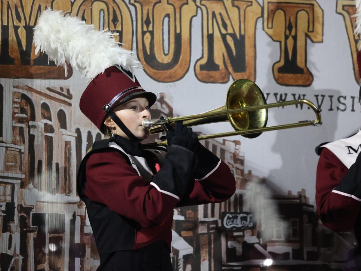 Senior Claire Thuerauf performs a duet during the marching band halftime show. 