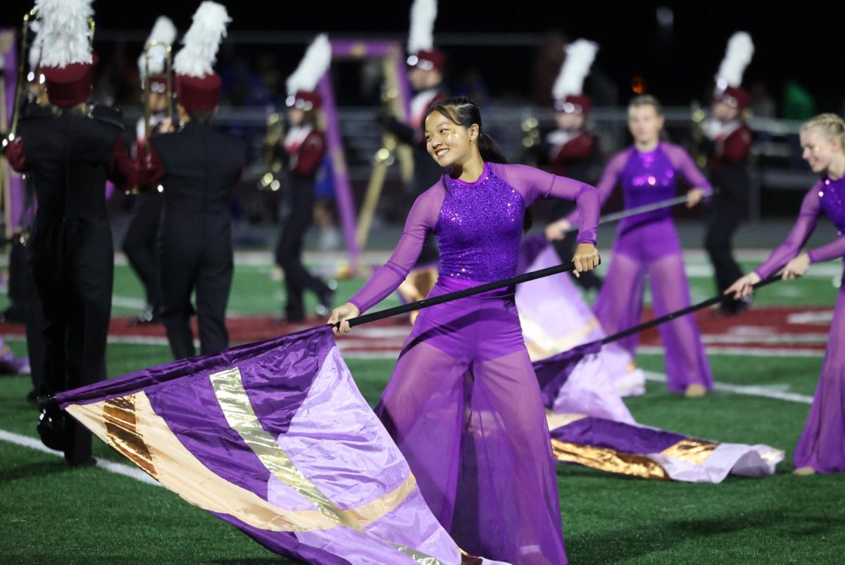 Sophomore Lexi Liu performs with the color guard during their show "Reminisce" on Sept. 5.