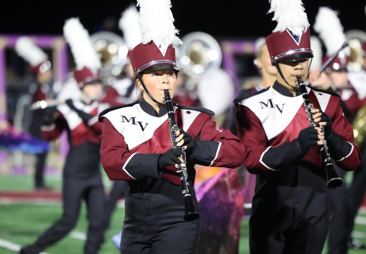 Juniors Natalee Glaister and Remington Klima march with the band during their performance on Sept. 5.