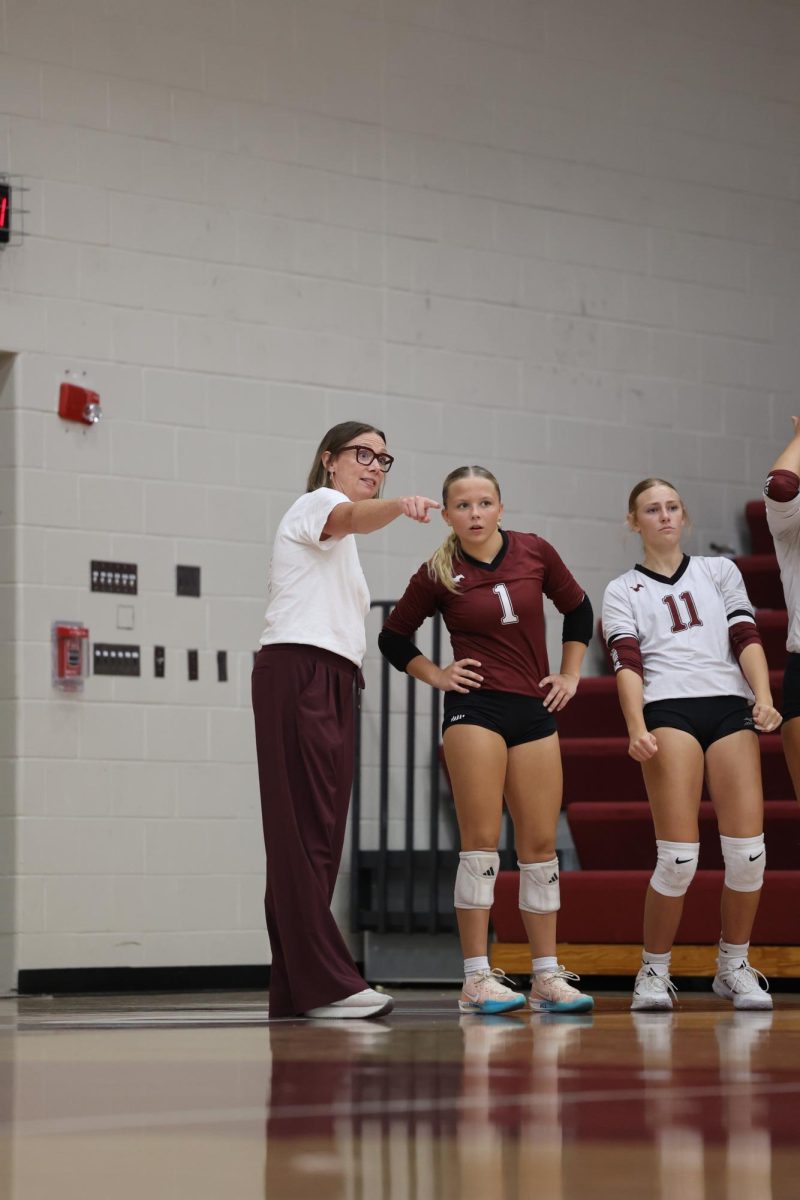 Junior Mavrik Schweer takes pointers from head coach Maggie Willems during their game on Sept. 16.