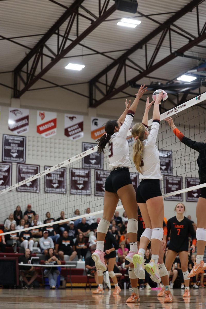 #3 Cali Whitaker and #5 Madison Hoffert jump to block the ball during their game on Sept. 16. 