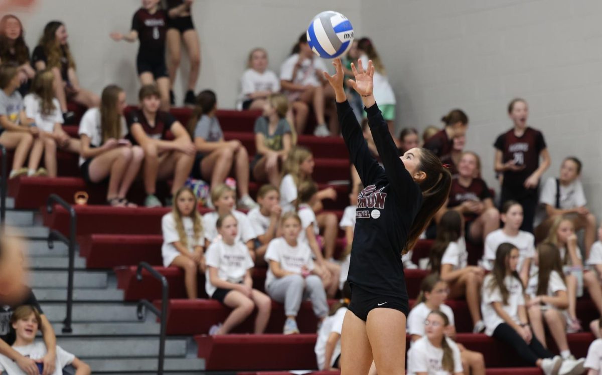 Senior Carly Elliot sets the ball during warmups.