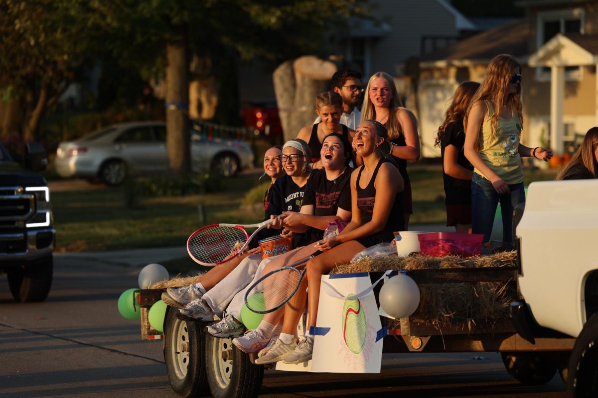 The Mount Vernon tennis team laughs as the candy they threw flies over the heads of the crowd.
